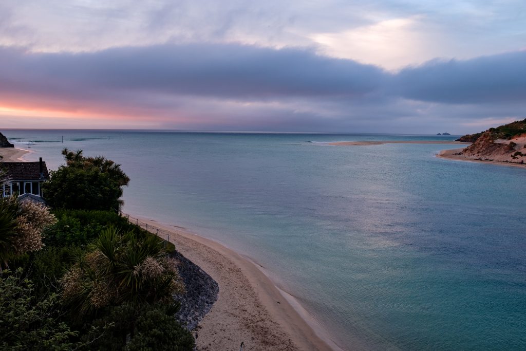 Beach House at Sunset pink skies and purple sea