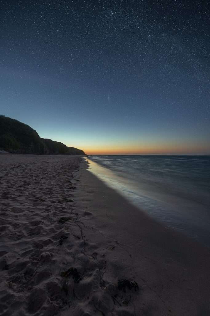 Sandy Beach at Night with stars in sky
