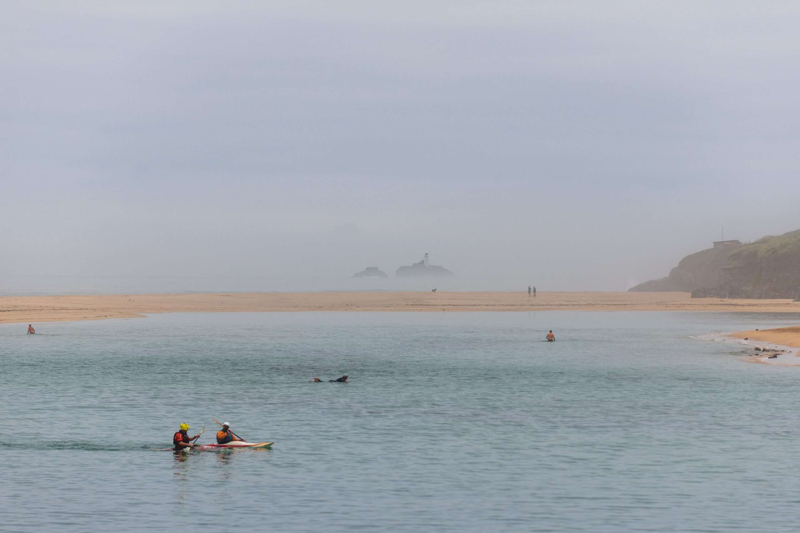 Kayakers with sea mist in distance